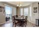 Bright dining area features a round table, hardwood floors, and a sliding door to the patio at 24351 E Alamo Dr, Aurora, CO 80016