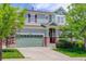 Charming two-story home with a two car garage, lush lawn and mature trees at 24351 E Alamo Dr, Aurora, CO 80016