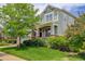 Charming two-story home with covered porch, lush lawn and mature trees at 24351 E Alamo Dr, Aurora, CO 80016