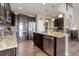 Kitchen features stainless steel appliances, dark wood cabinets, and granite countertops at 24351 E Alamo Dr, Aurora, CO 80016