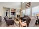 Cozy living room with fireplace, large windows, and comfortable seating at 24351 E Alamo Dr, Aurora, CO 80016