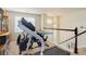 Upper level loft featuring exercise equipment and a view of the staircase at 24351 E Alamo Dr, Aurora, CO 80016