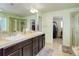 Bright main bathroom with double sinks, walk-in shower, and a closet for organization at 24351 E Alamo Dr, Aurora, CO 80016