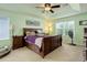 Spacious main bedroom with tray ceiling, a fan, a large window and matching furniture set at 24351 E Alamo Dr, Aurora, CO 80016