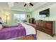Relaxing main bedroom features a tray ceiling, a fan, matching furniture and large window views at 24351 E Alamo Dr, Aurora, CO 80016
