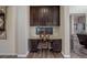 Home office with built-in desk, dark wood cabinetry, and natural light at 24351 E Alamo Dr, Aurora, CO 80016