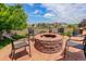 Inviting patio with a fire pit, chairs, and mature landscaping at 24351 E Alamo Dr, Aurora, CO 80016