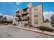 Inviting condo with brick accents and multiple balconies on a sunny day at 15350 E Arizona Ave # 106, Aurora, CO 80017
