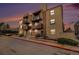 Inviting condo with brick accents and multiple balconies, set against a vibrant sunset sky at 15350 E Arizona Ave # 106, Aurora, CO 80017