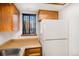 Efficient kitchen space featuring wood cabinets, laminate countertop, and a modern refrigerator at 15350 E Arizona Ave # 106, Aurora, CO 80017