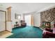 Cozy living room featuring a stone fireplace, plush carpeting, and natural light at 15350 E Arizona Ave # 106, Aurora, CO 80017