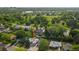 An aerial view of the home, surrounded by mature trees and lush green lawns at 1648 S Locust St, Denver, CO 80224