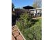 Charming backyard with lush flower beds, a spacious deck, and verdant green grass at 1648 S Locust St, Denver, CO 80224
