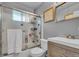 Modern bathroom featuring a sleek vanity and a glass-enclosed shower at 1648 S Locust St, Denver, CO 80224