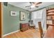 Inviting bedroom with olive green walls, wood floors, and natural lighting at 1648 S Locust St, Denver, CO 80224