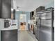Kitchen featuring sleek stainless steel appliances, granite countertops, and tile floors at 1648 S Locust St, Denver, CO 80224