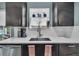 Close-up of the kitchen sink area with modern fixtures and stylish decor at 1648 S Locust St, Denver, CO 80224