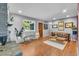 Bright living room featuring hardwood floors, a brick fireplace, and comfortable seating at 1648 S Locust St, Denver, CO 80224