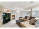 Cozy basement with a large sectional sofa, TV, and built-in shelving at 9109 Ironwood Way, Highlands Ranch, CO 80129