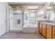 Bright bathroom featuring a glass enclosed shower, soaking tub, double vanities, and arched windows at 9109 Ironwood Way, Highlands Ranch, CO 80129