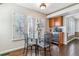 Cozy breakfast nook with bright windows, a modern glass table, and stylish seating at 9109 Ironwood Way, Highlands Ranch, CO 80129