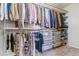 Organized walk-in closet with shelving and hanging storage for clothes and accessories at 9109 Ironwood Way, Highlands Ranch, CO 80129
