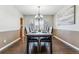 Elegant dining area features a dark wood table with seating for six, stylish lighting, and a cozy atmosphere at 9109 Ironwood Way, Highlands Ranch, CO 80129
