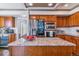Modern kitchen with stainless steel appliances, a spacious center island, and custom wood cabinetry at 9109 Ironwood Way, Highlands Ranch, CO 80129