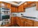 Well-appointed kitchen with modern appliances, granite countertops, and rich wood cabinetry at 9109 Ironwood Way, Highlands Ranch, CO 80129