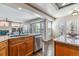 Bright kitchen featuring granite countertops, a stainless steel dishwasher, and ample natural light at 9109 Ironwood Way, Highlands Ranch, CO 80129