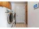 Functional laundry room equipped with modern washer and dryer units at 9109 Ironwood Way, Highlands Ranch, CO 80129