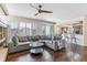 Open concept living room and kitchen with dark wood floors and a comfortable gray couch at 9109 Ironwood Way, Highlands Ranch, CO 80129