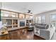 Open living room featuring a large comfortable couch, fireplace, and built in shelving at 9109 Ironwood Way, Highlands Ranch, CO 80129