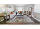 Bright and airy living room with a decorative rug, piano, comfortable sofas, and an inviting atmosphere at 9109 Ironwood Way, Highlands Ranch, CO 80129