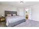 Serene main bedroom with a padded headboard and view to the bath at 9109 Ironwood Way, Highlands Ranch, CO 80129