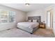 Calm main bedroom featuring an upholstered headboard and side table with lamps at 9109 Ironwood Way, Highlands Ranch, CO 80129