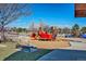 A colorful playground with slides, climbing structures, and swings amidst a landscaped play area on a sunny day at 9109 Ironwood Way, Highlands Ranch, CO 80129