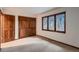 Bright bedroom featuring large windows with natural light, ample closet space and neutral carpeting at 900 Poplar Ave, Boulder, CO 80304