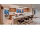 An airy kitchen featuring wooden cabinets, bar seating, and an adjoining dining area at 900 Poplar Ave, Boulder, CO 80304