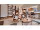 Open-concept living area with hardwood floors, built-in shelves, and kitchen access, perfect for entertaining at 900 Poplar Ave, Boulder, CO 80304