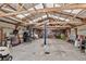 The interior view of the large barn reveals metal walls, and a translucent ceiling with wooden beams at 68251 E 96Th Ave, Byers, CO 80103