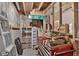 This unfinished basement features concrete walls and ceiling with various storage and workshop items at 68251 E 96Th Ave, Byers, CO 80103
