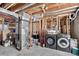 Unfinished basement with exposed beams and ductwork, includes washer, dryer and storage at 68251 E 96Th Ave, Byers, CO 80103