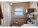 Bathroom featuring a shower with curtain and a wooden look wall, and a nice vanity at 68251 E 96Th Ave, Byers, CO 80103