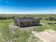 Single-story home with neutral siding, gray roof, white front door, and ample green grass at 68251 E 96Th Ave, Byers, CO 80103