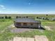 Single-story home with neutral siding, gray roof, concrete porch and white front door at 68251 E 96Th Ave, Byers, CO 80103