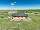 Home with tan siding, gray roof, a barn, green lawn, and blue skies at 68251 E 96Th Ave, Byers, CO 80103