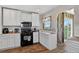 Practical kitchen with white cabinetry and a stainless steel microwave above the range oven at 68251 E 96Th Ave, Byers, CO 80103