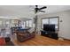 Open-concept living room featuring hardwood floors, comfortable seating, and a ceiling fan at 68251 E 96Th Ave, Byers, CO 80103