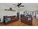 Spacious living room featuring wood floors, comfortable seating, and a ceiling fan at 68251 E 96Th Ave, Byers, CO 80103